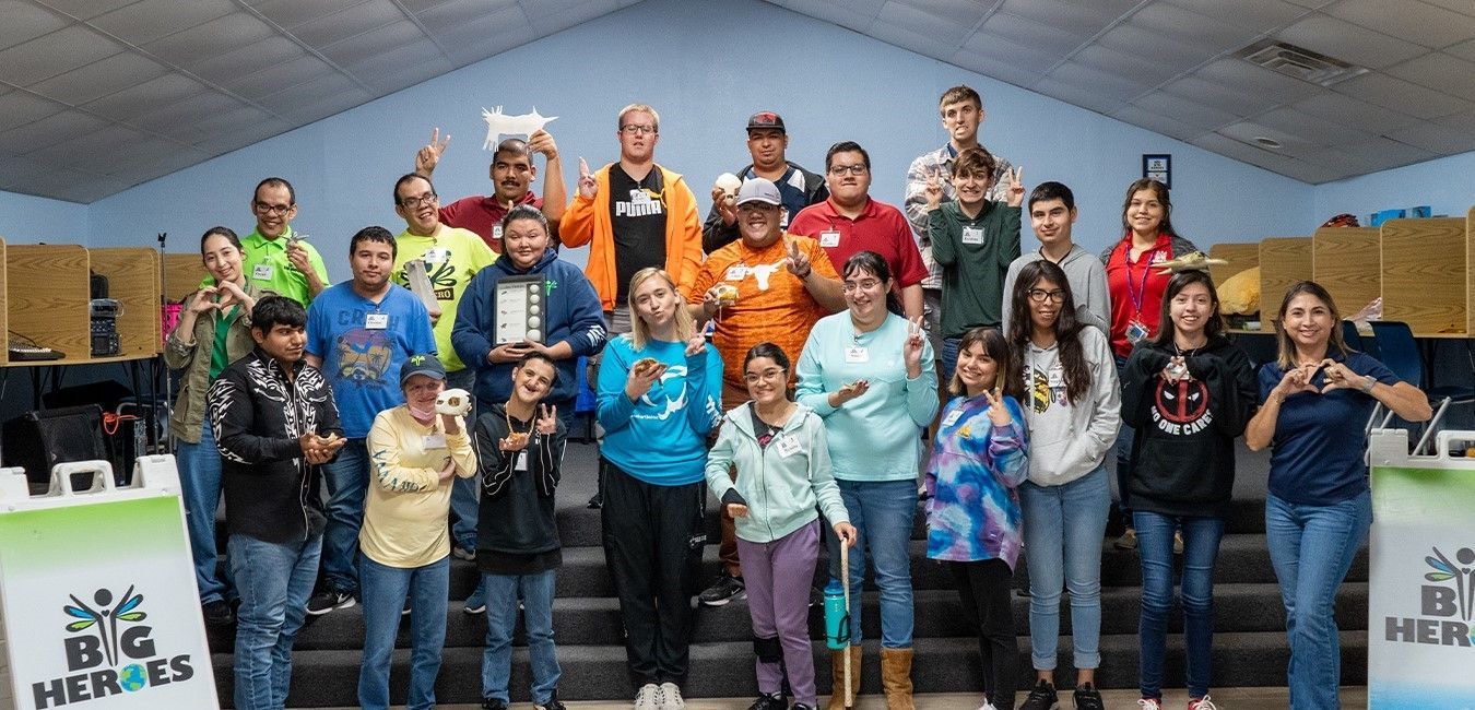 A group of people are posing for a picture in a room.