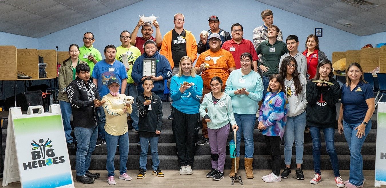 A large group of people are posing for a picture in a room.