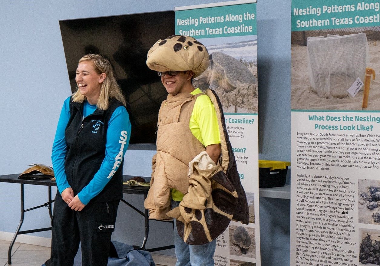 A man in a mushroom costume is standing next to a woman.