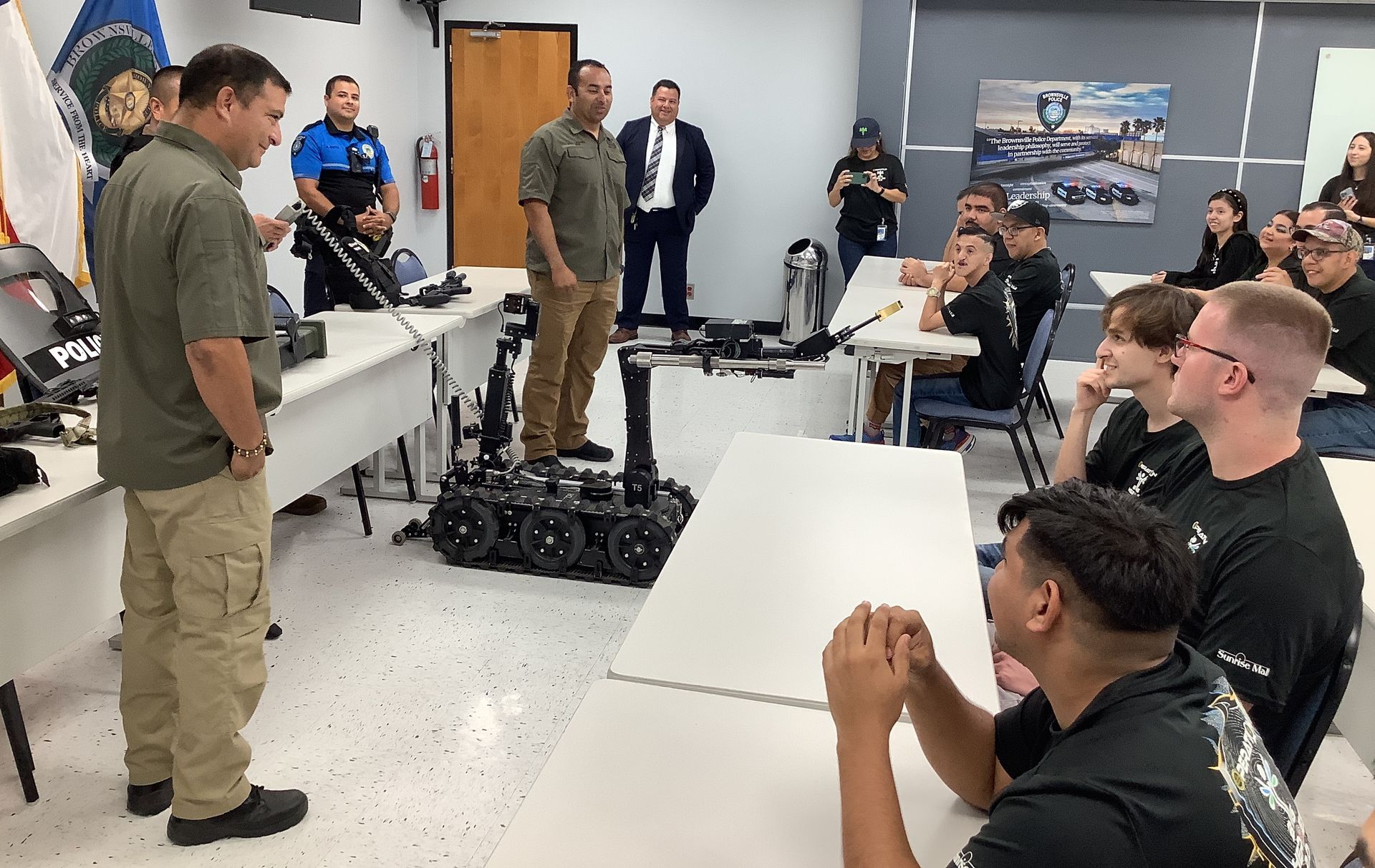 A group of men are sitting at tables in a room.