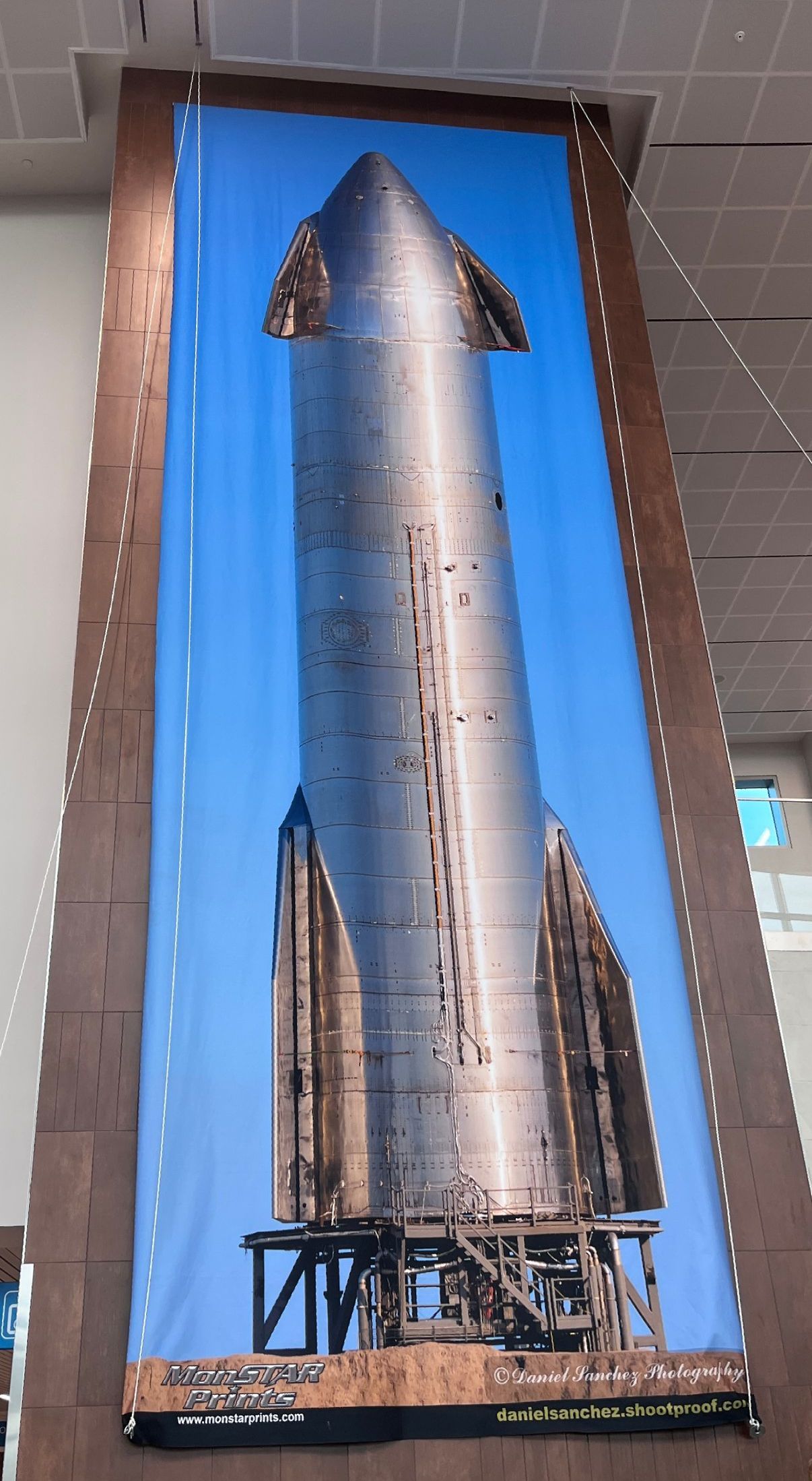 A large picture of a rocket is hanging on a wall.