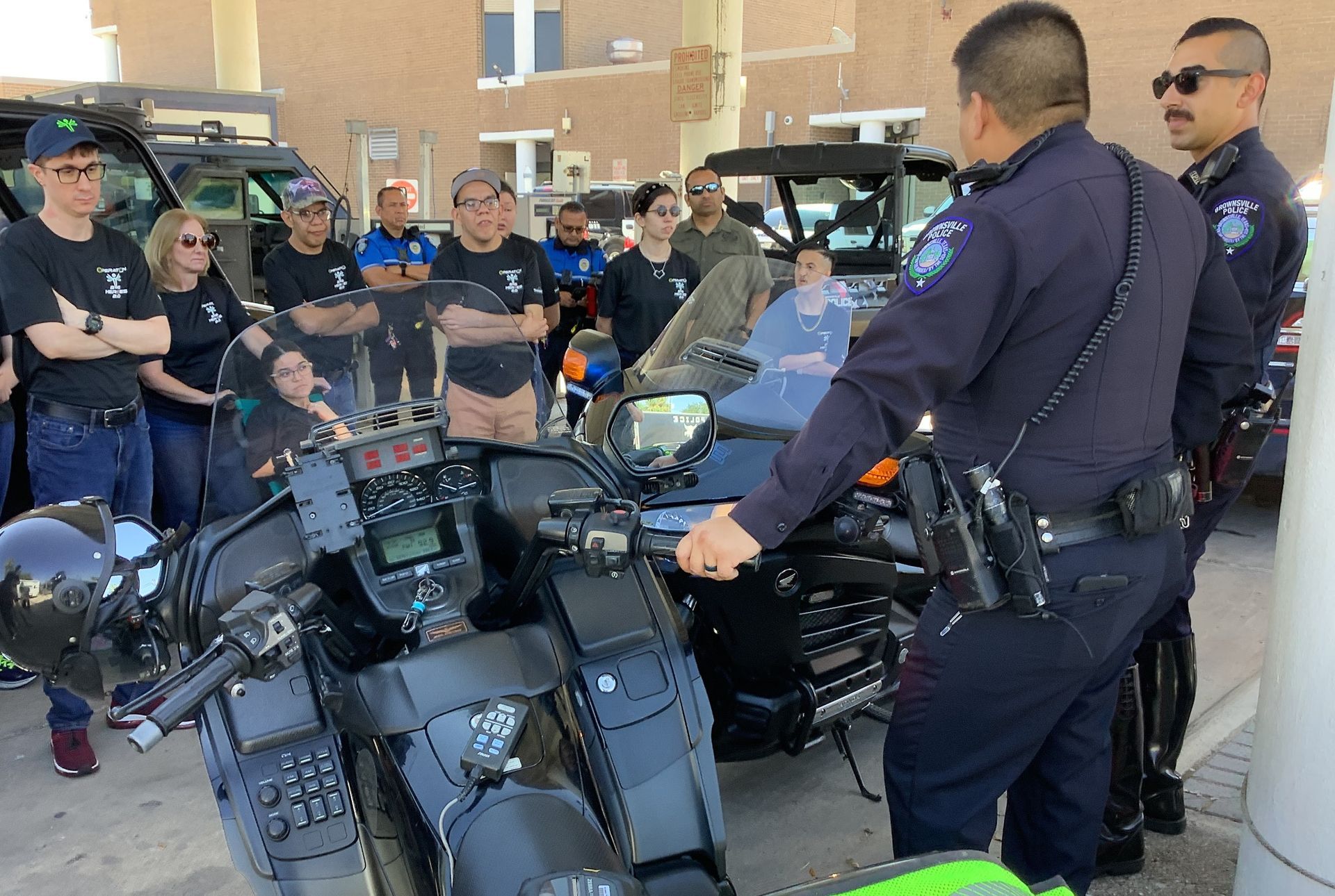 A group of police officers standing around a motorcycle