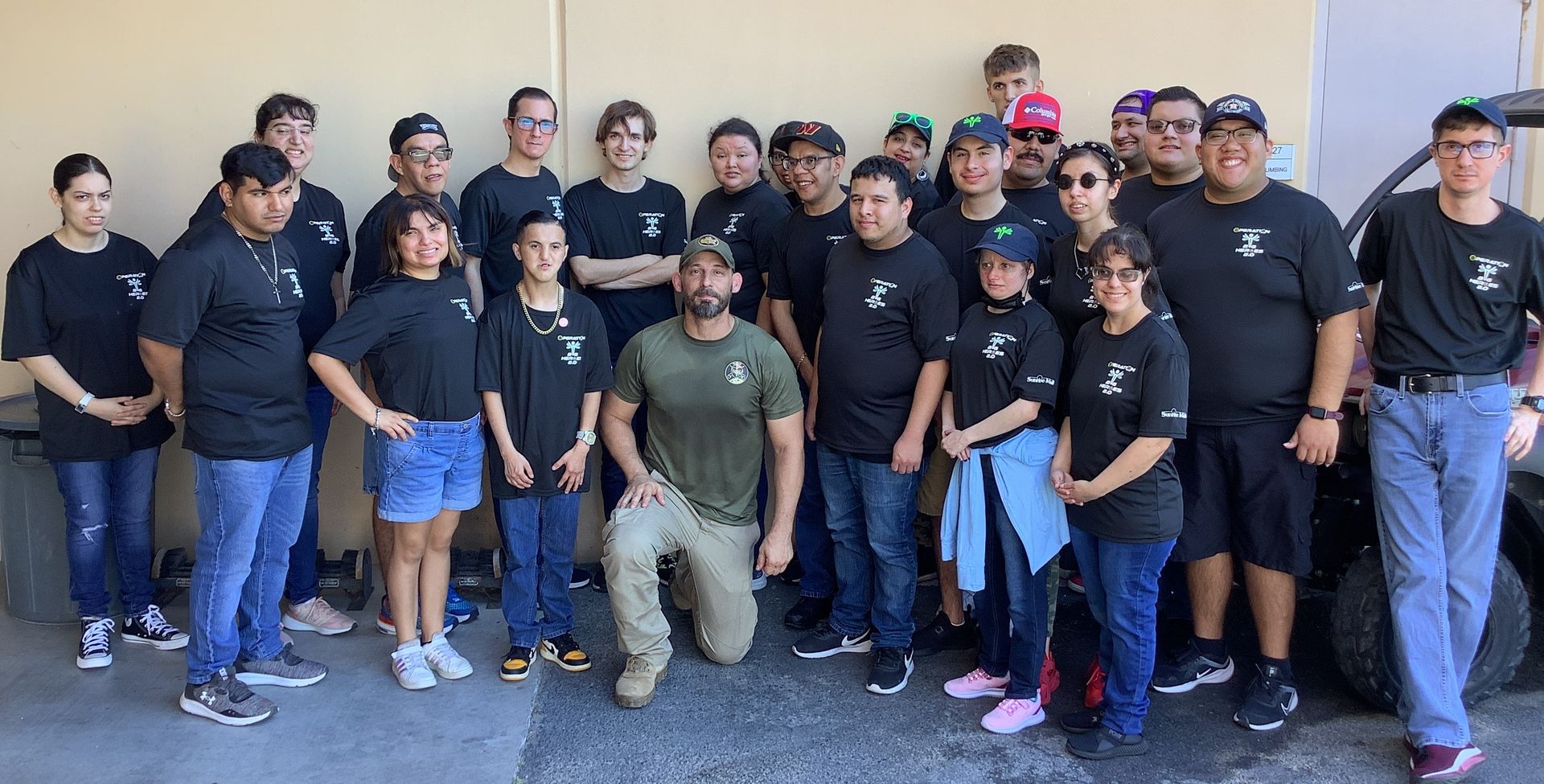 A group of people are posing for a picture in front of a building.