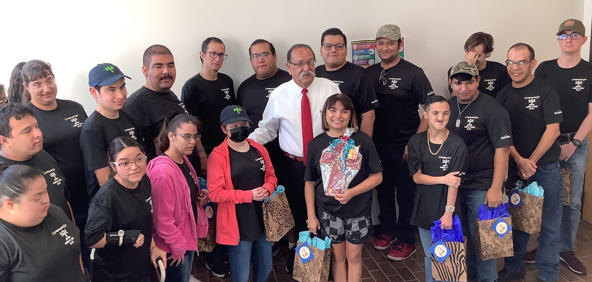 A group of people are posing for a picture in a room.