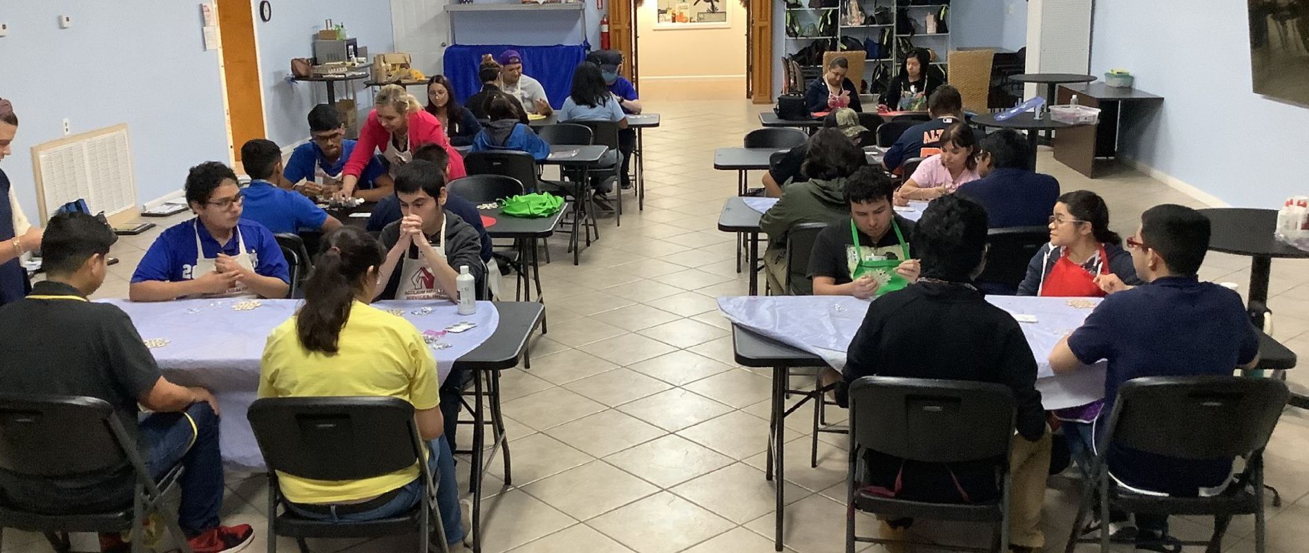 A group of people are sitting at tables in a room.