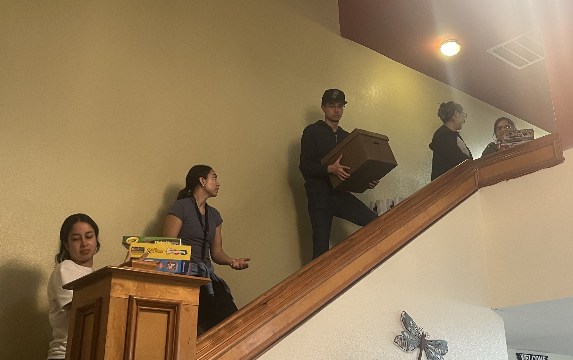 A group of people are moving up a set of stairs.