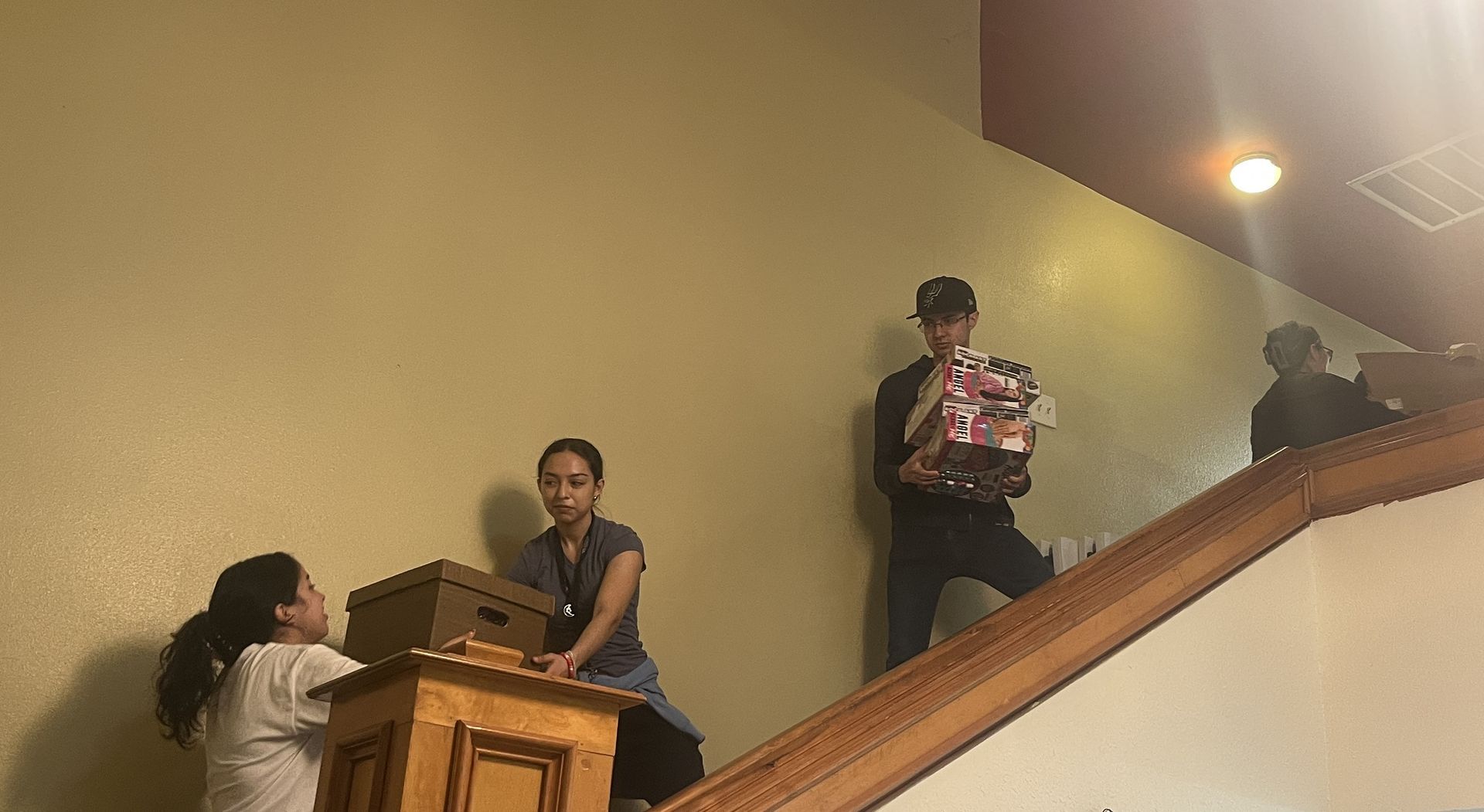 A group of people are moving up a set of stairs.