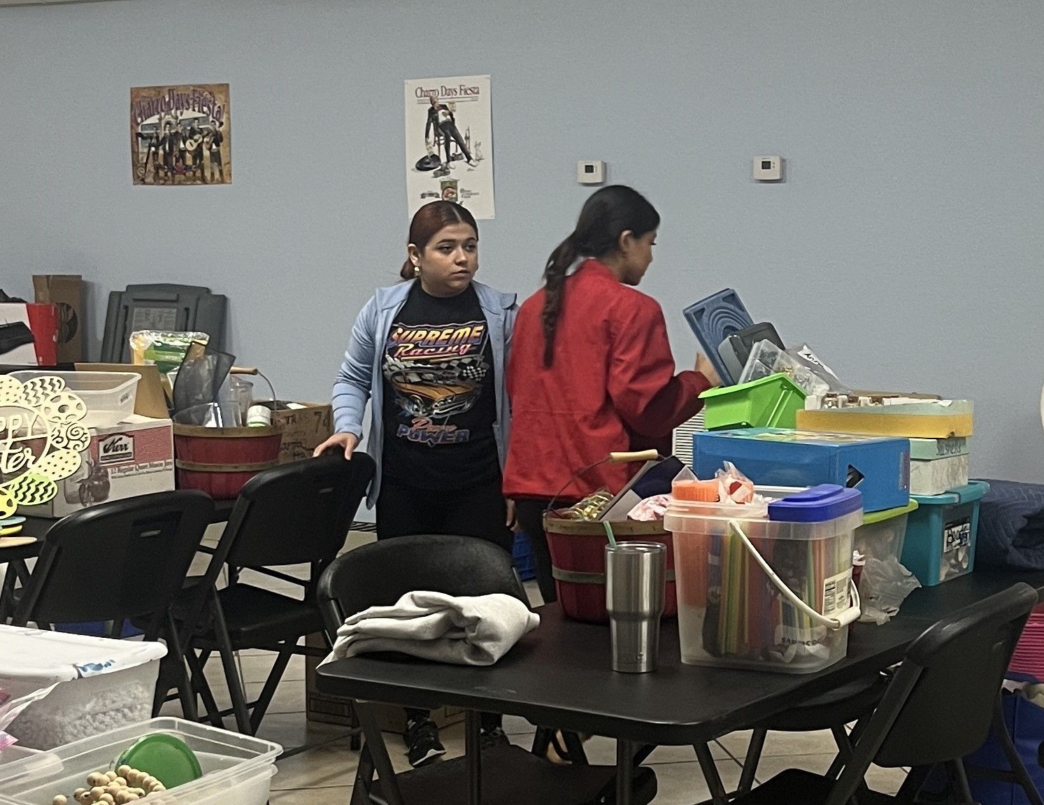 A group of people are standing around a table in a room.