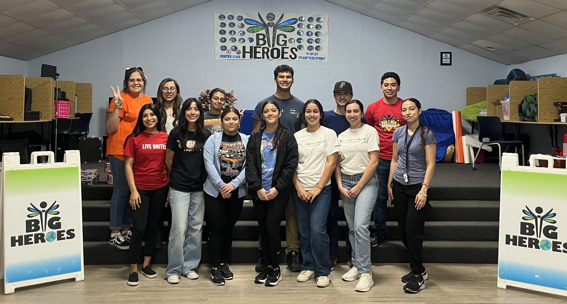 A group of people are posing for a picture in a room.