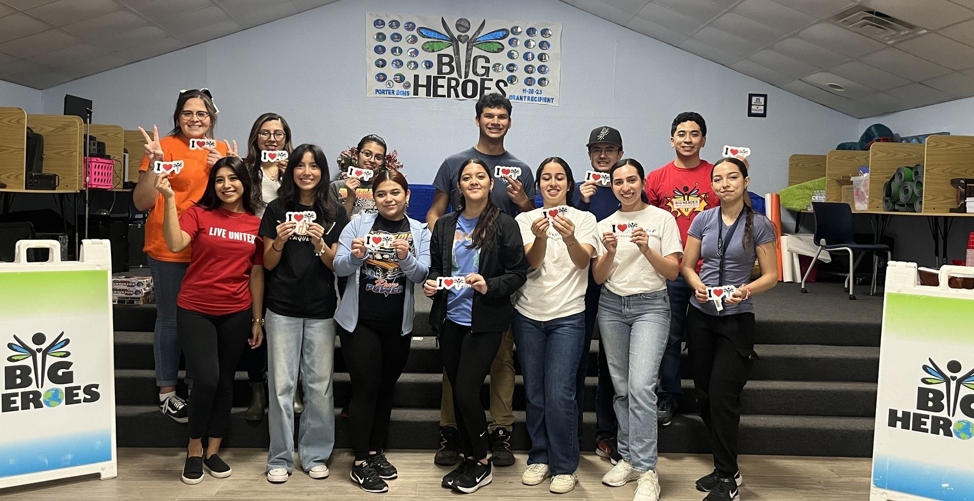 A group of people are posing for a picture in a room.