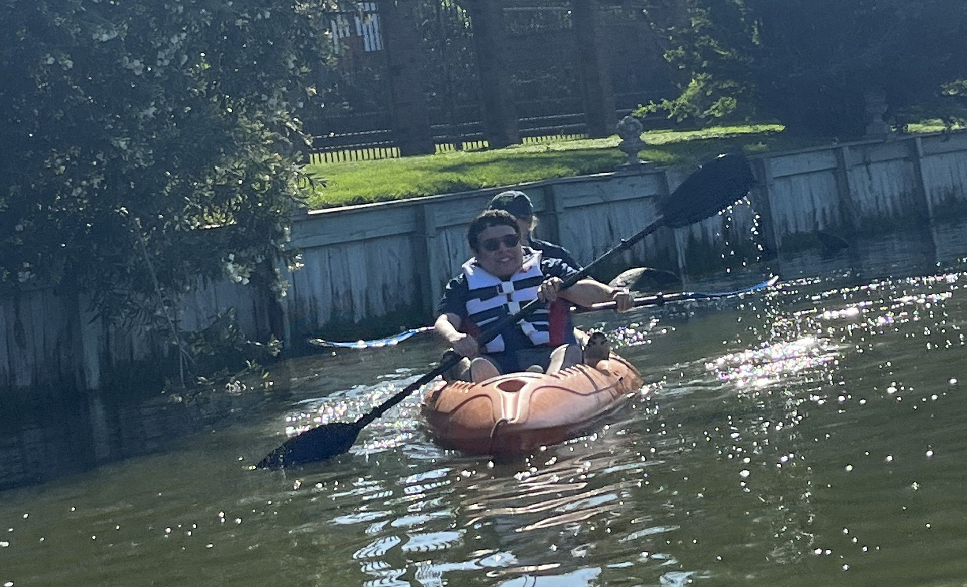 A man is paddling a kayak on a river