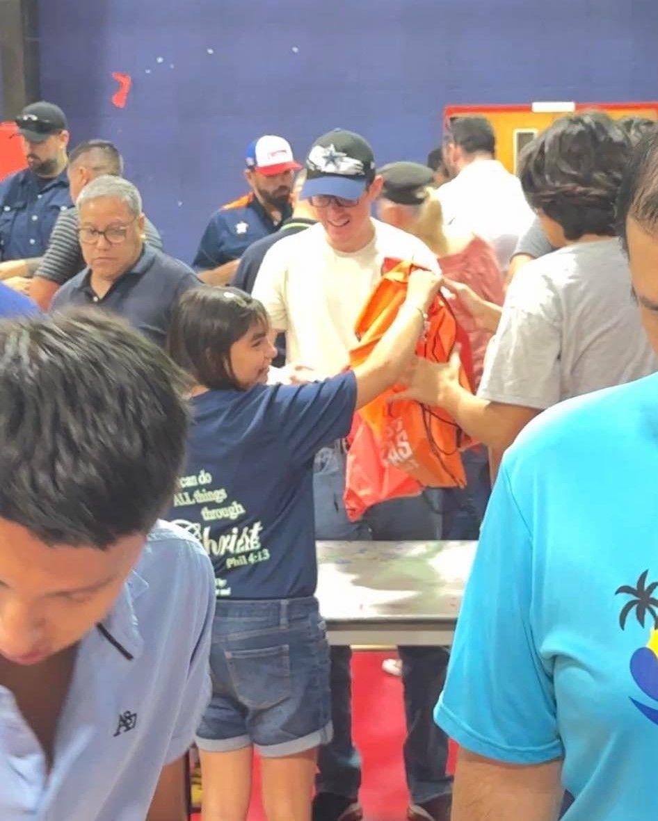 A girl in a blue shirt that says ' astrid ' on it