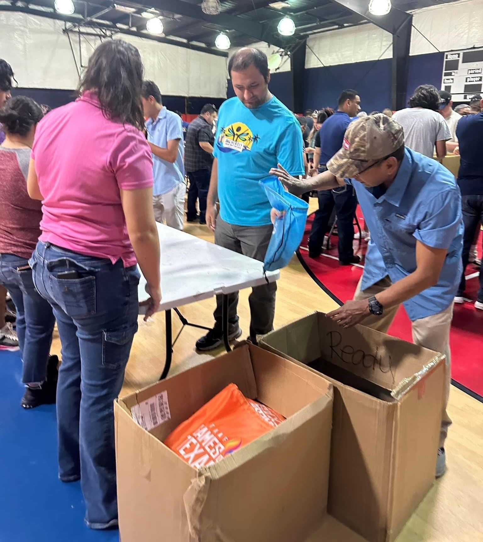 A man in a blue shirt is standing next to a woman in a pink shirt