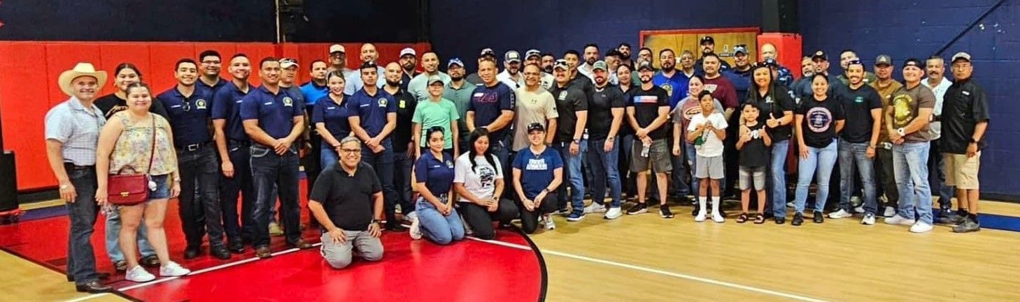 A large group of people are posing for a picture in a gym.