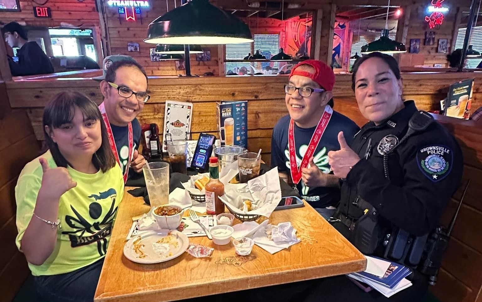 A group of people are sitting at a table in a restaurant.