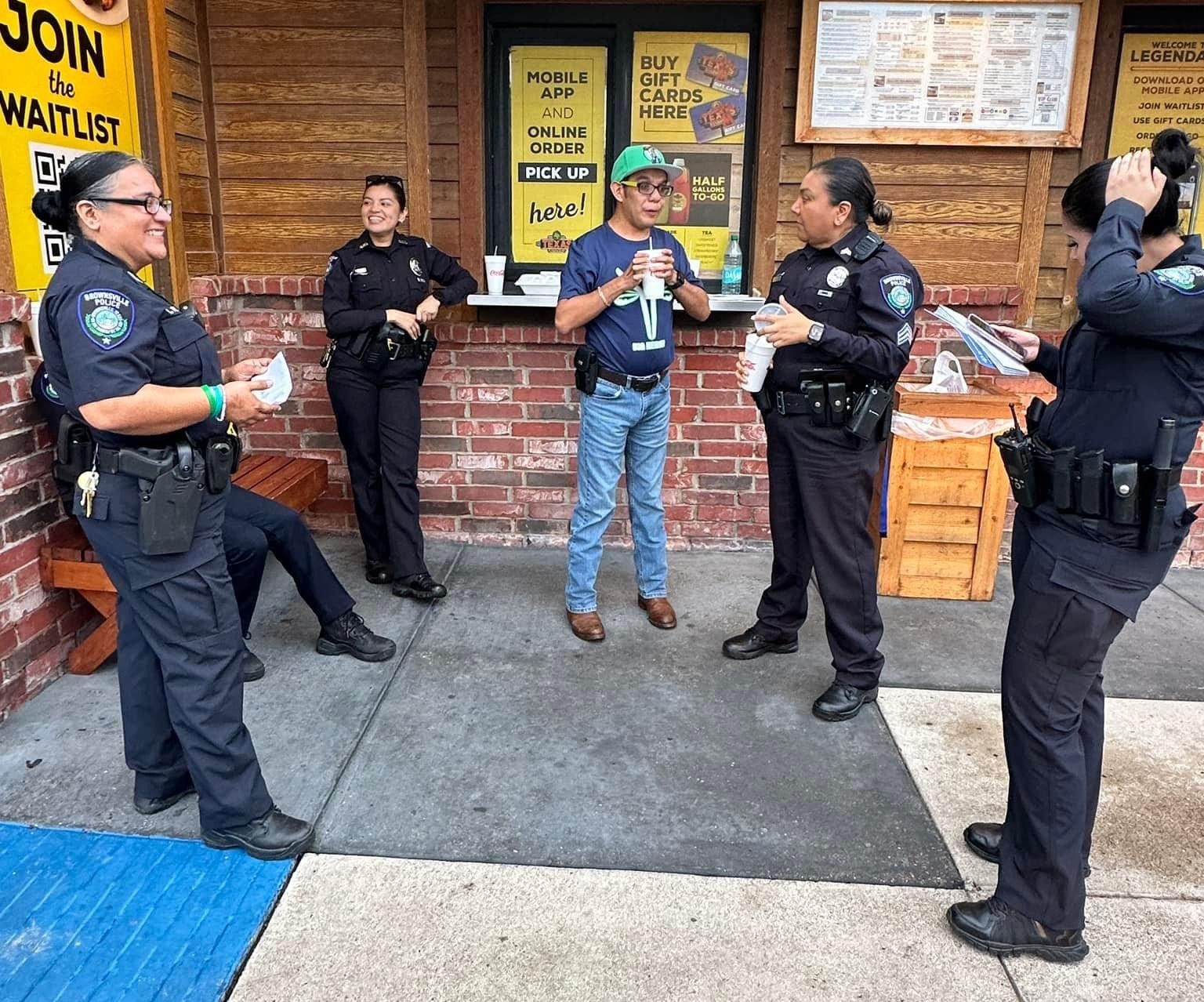 A group of police officers standing outside of a restaurant