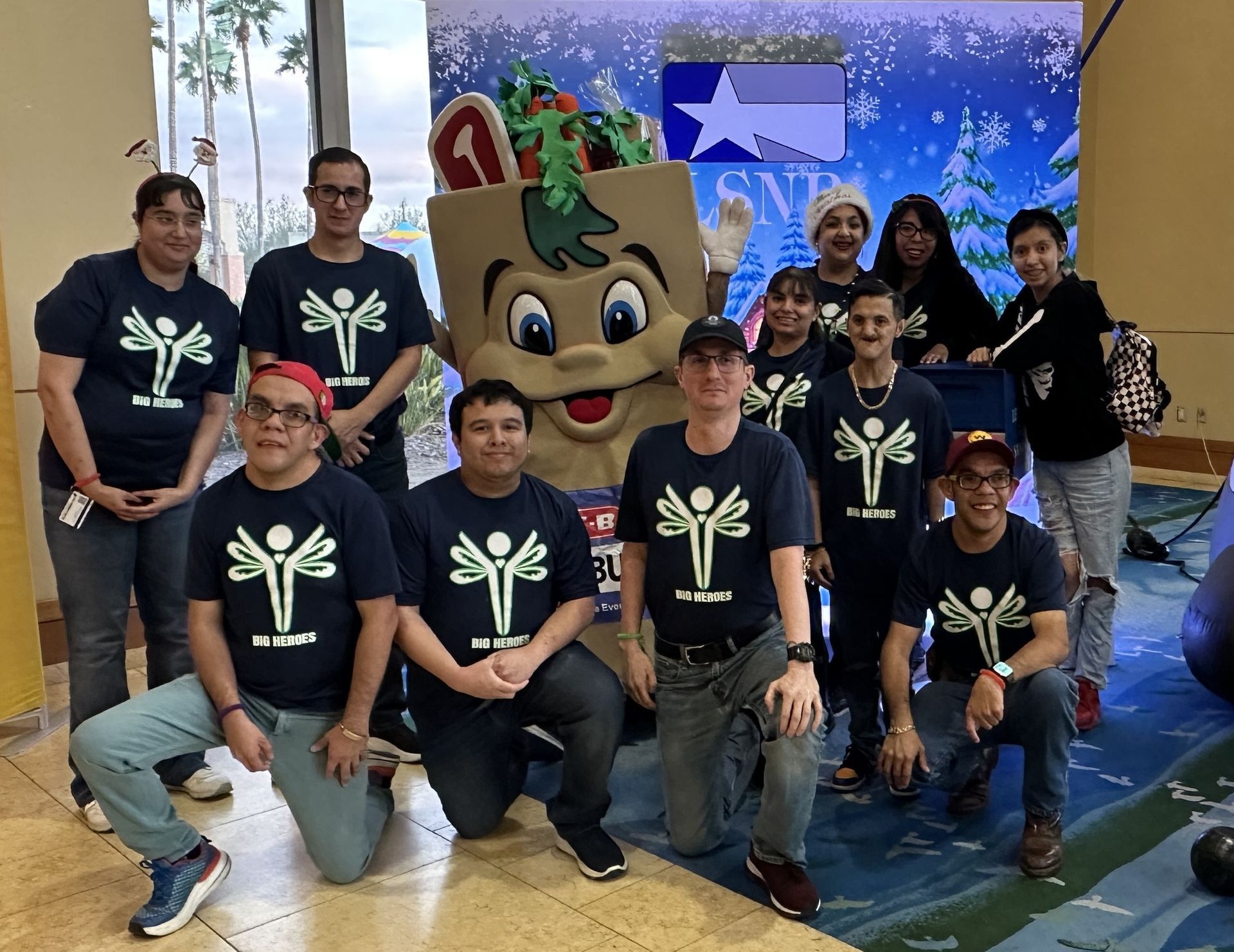A group of people posing for a picture with a mascot