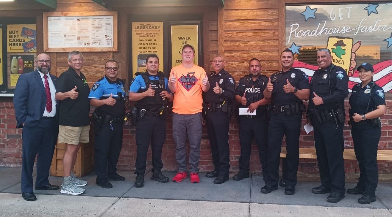 A group of police officers are posing for a picture