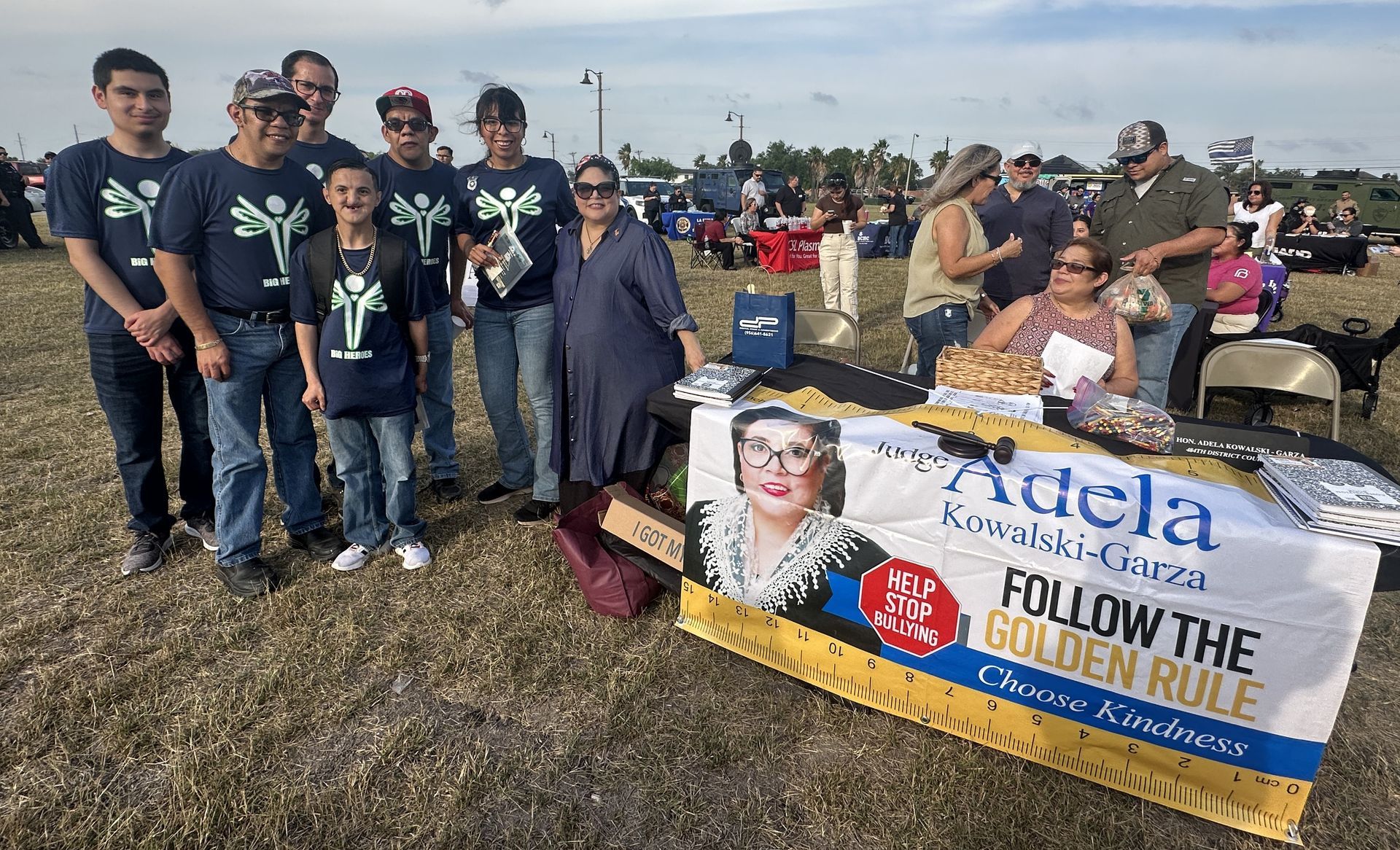 A group of people standing around a table with a sign that says `` follow the golden rule ''.