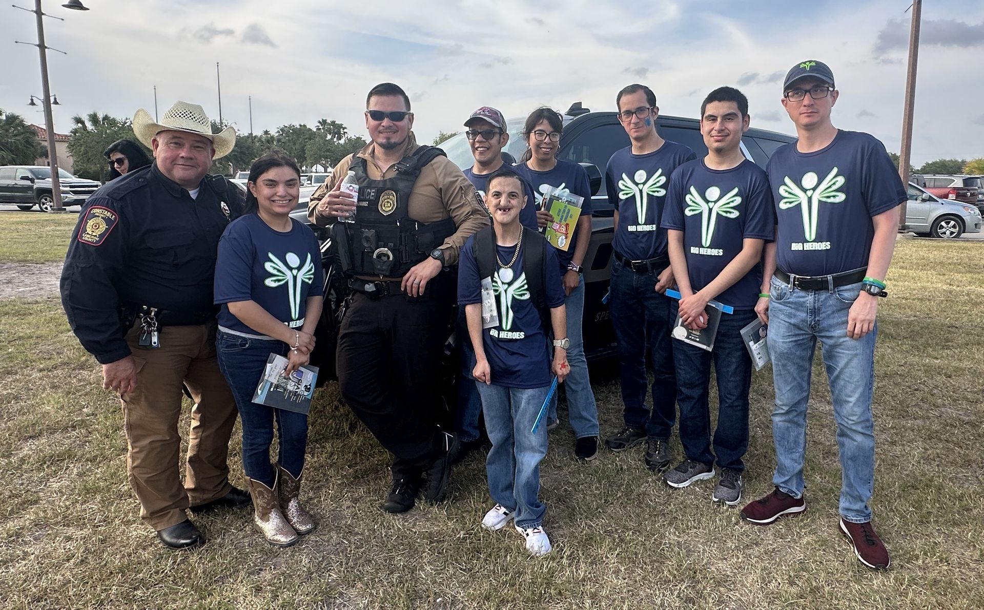 A group of people standing next to each other in a field.