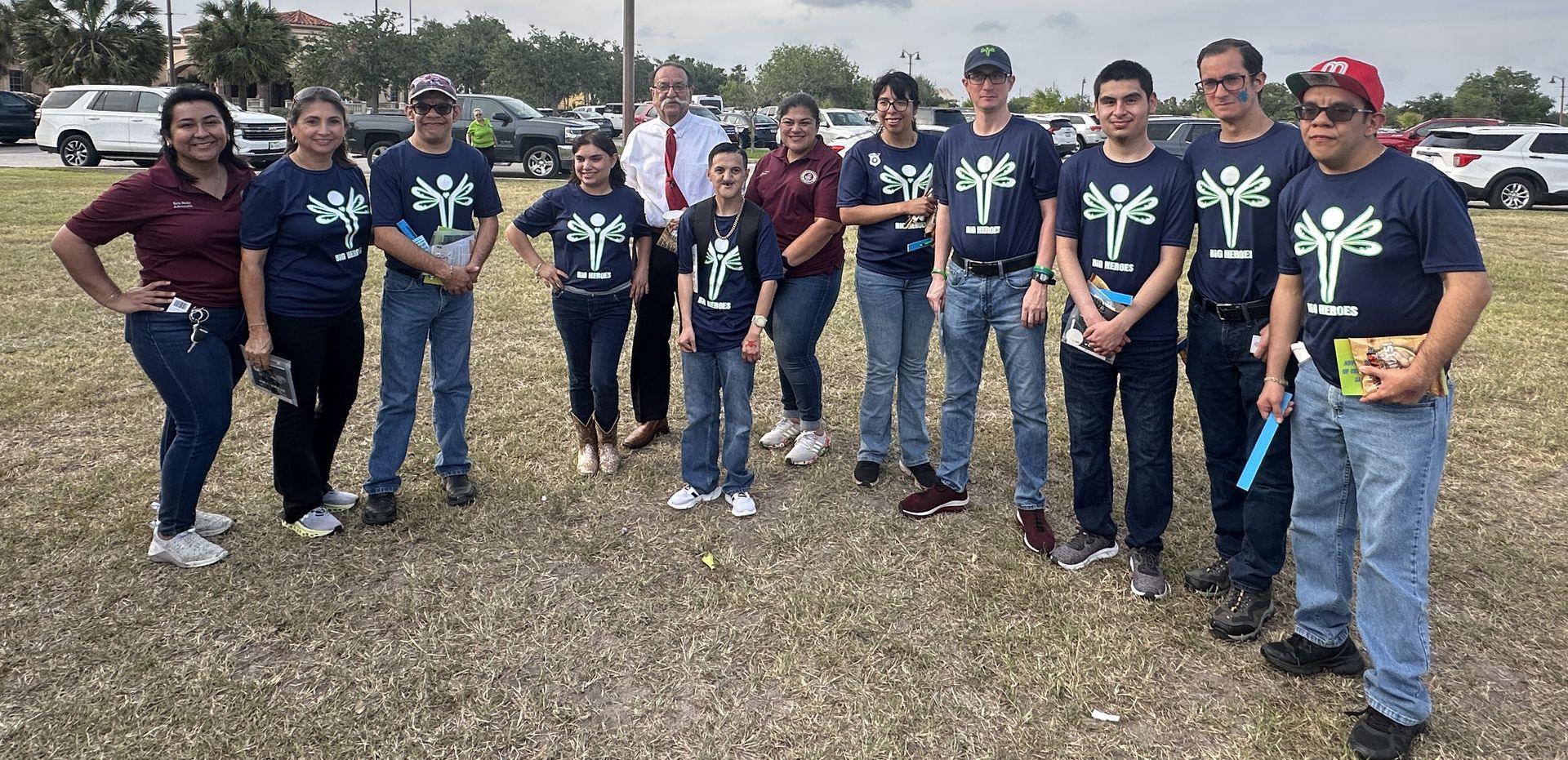 A group of people are posing for a picture in a field.