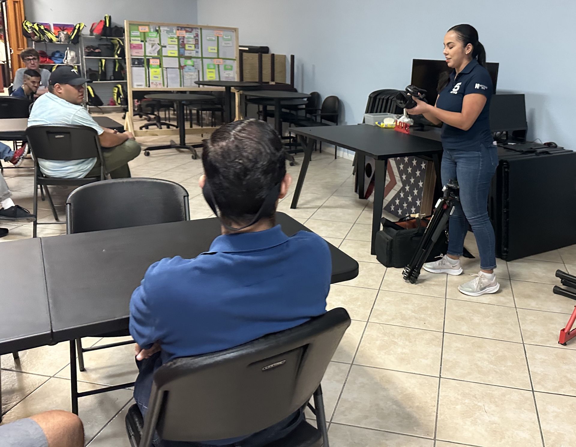 A woman is giving a presentation to a group of people