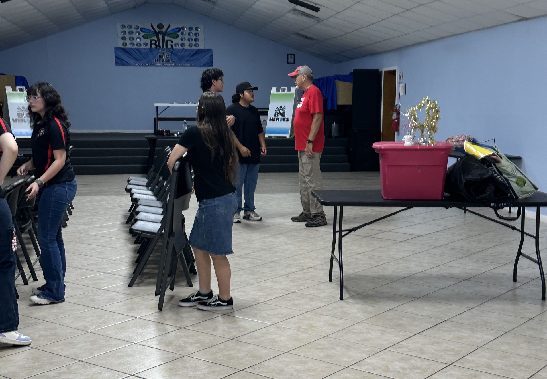 A group of people standing around a table in a room