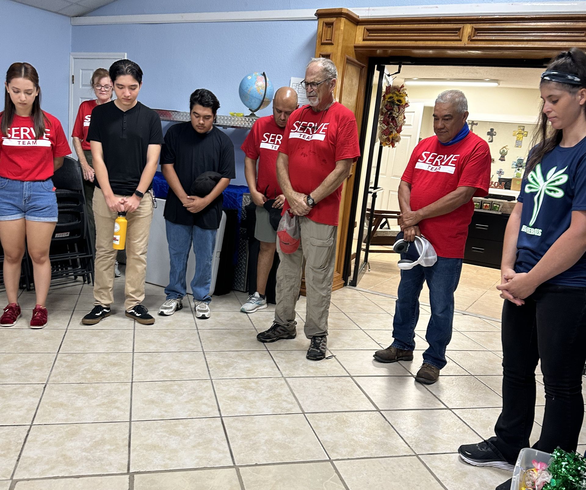 A group of people wearing red shirts with the word jesus on them