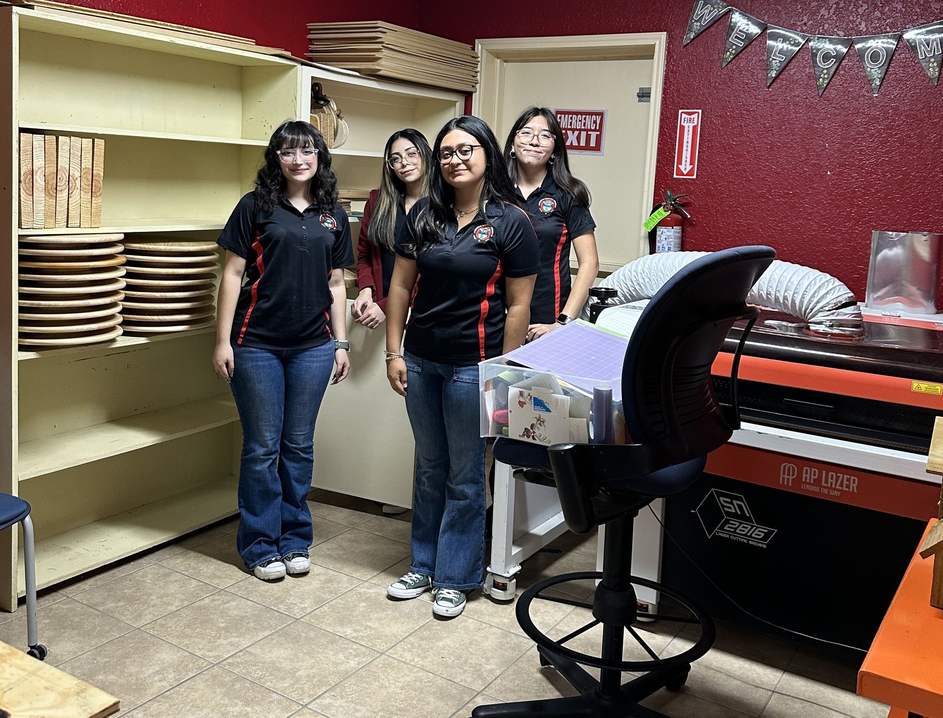 A group of women are standing in a room next to a piano.