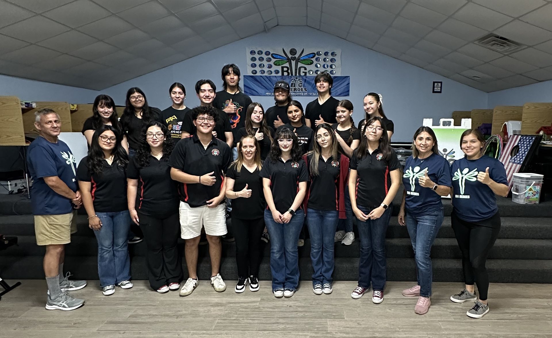 A group of people are posing for a picture in a room.