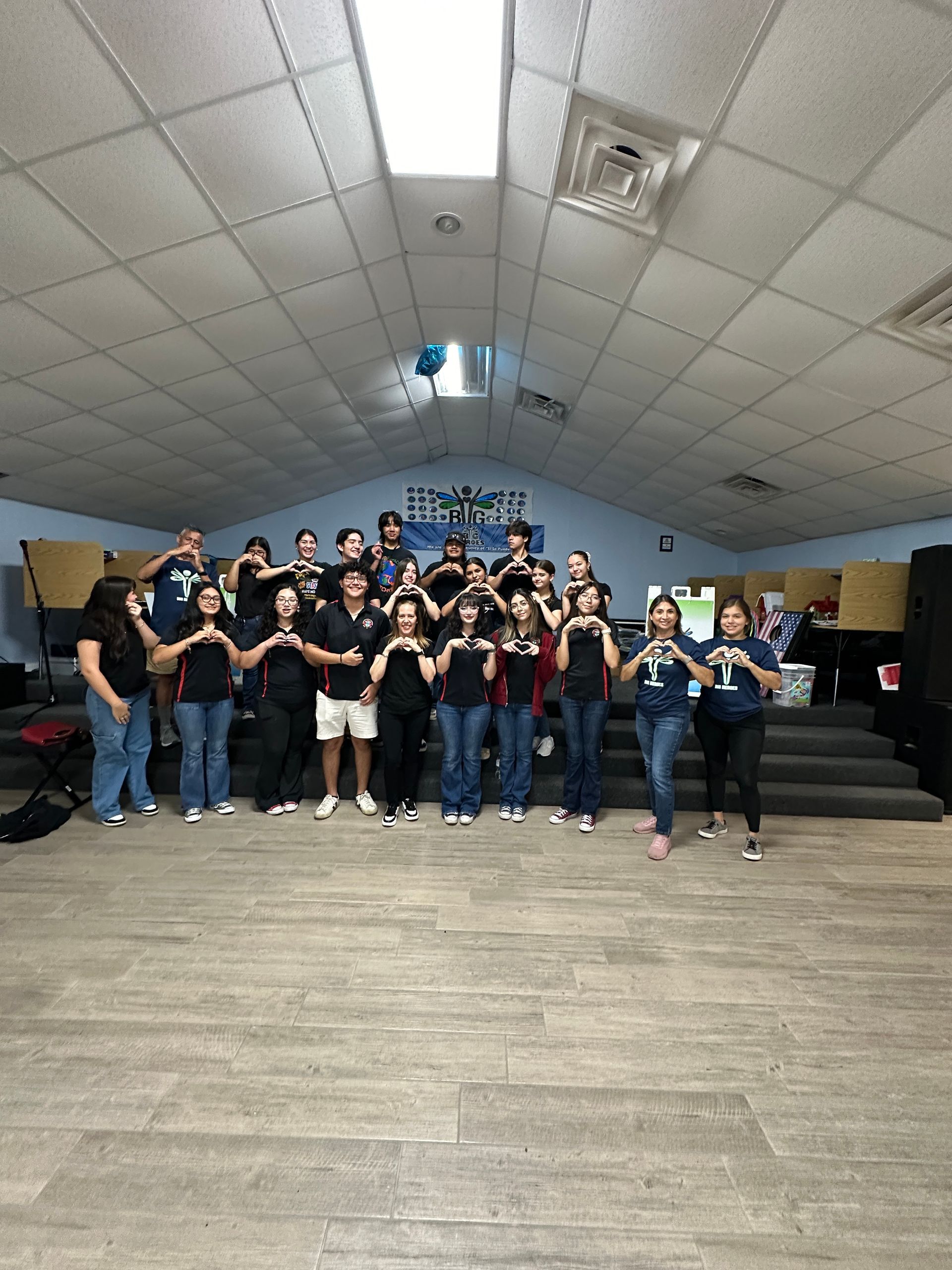 A group of people are posing for a picture in a room.