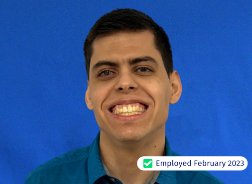 A man in a blue shirt is smiling and has been employed since february 2023
