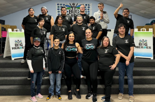 A group of people wearing black shirts are posing for a picture.