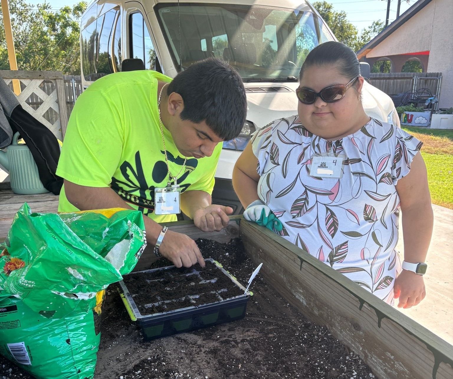 A man and a woman are working in a garden.