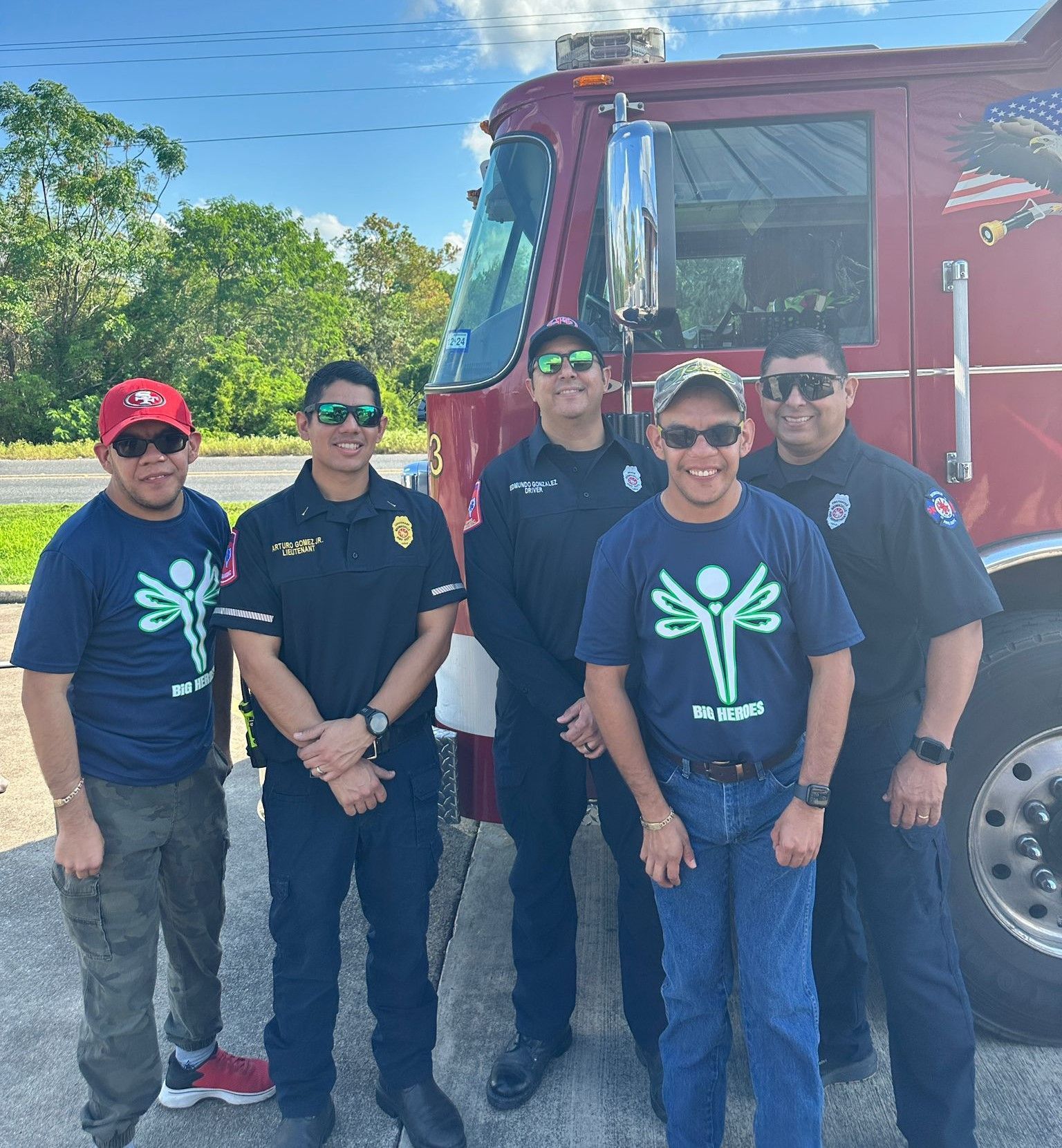 A group of men standing in front of a fire truck