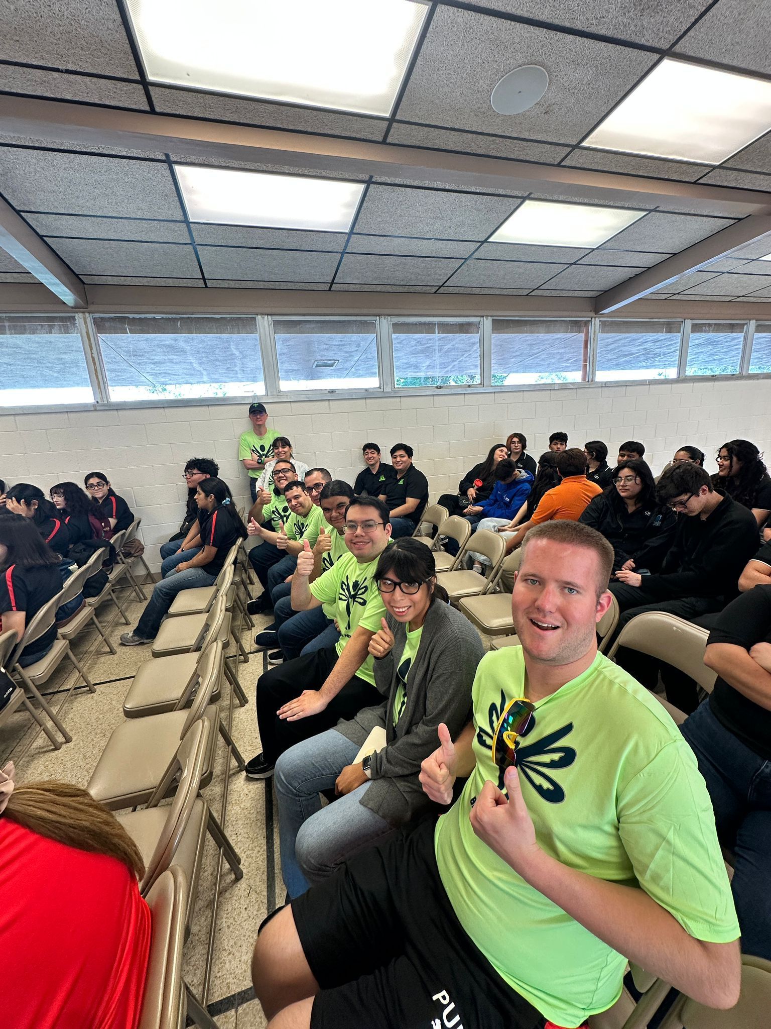 A group of people are sitting in chairs in a room.
