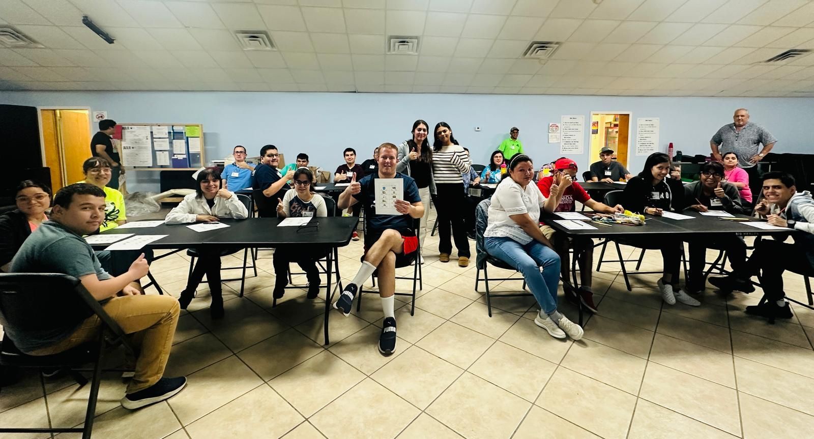 A group of people are sitting at tables in a room.