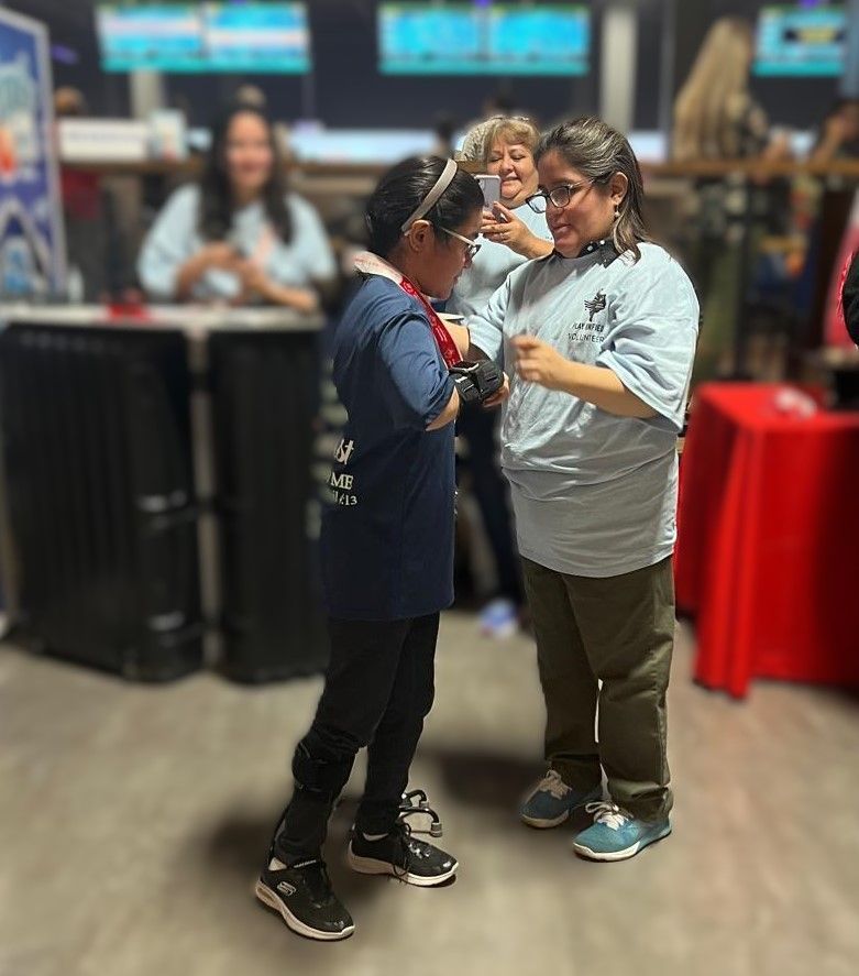 Two women are standing next to each other in a room