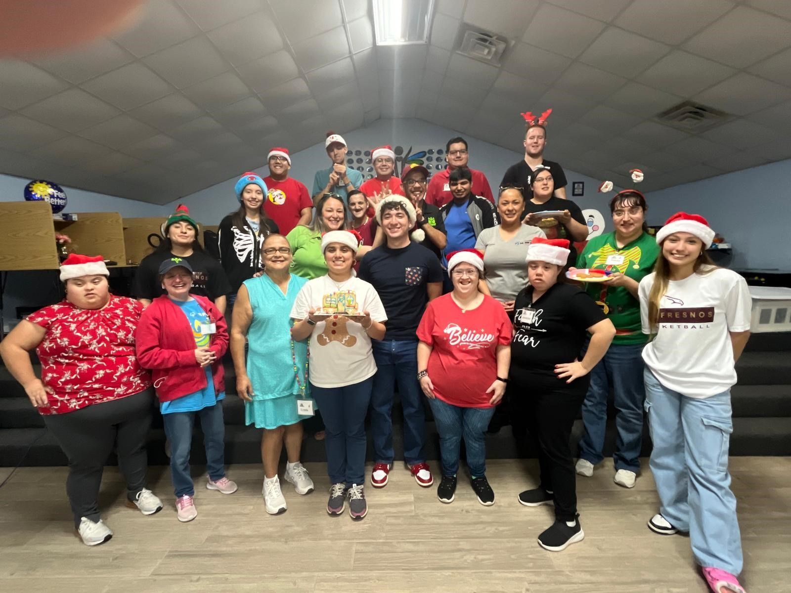 A group of people wearing santa hats are posing for a picture.