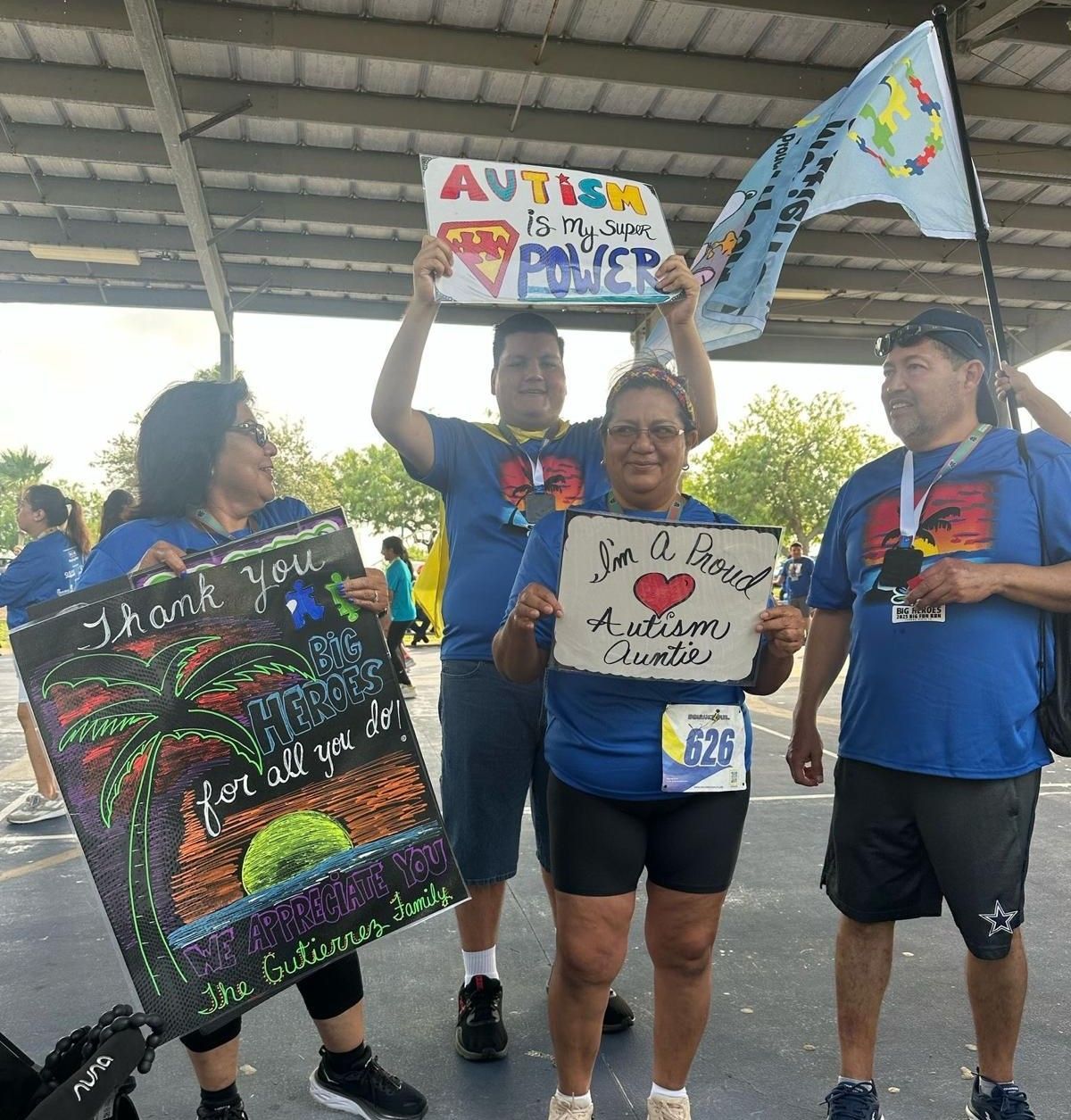 A group of people holding up signs that say thank you for all you do