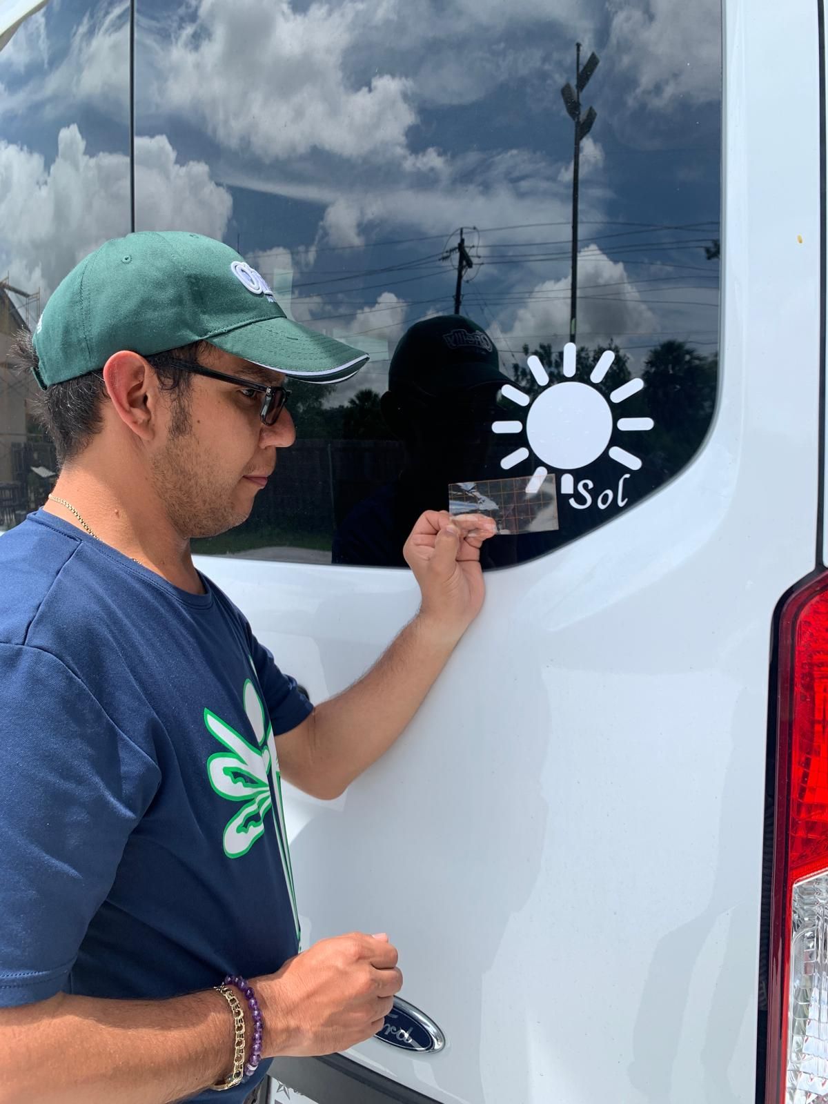 Man applying a white sun sticker with