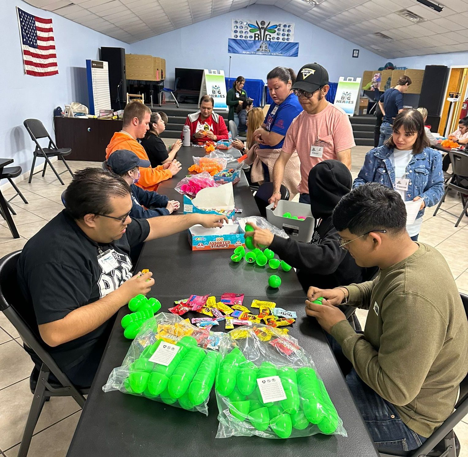A group of people are sitting around a table playing with toys