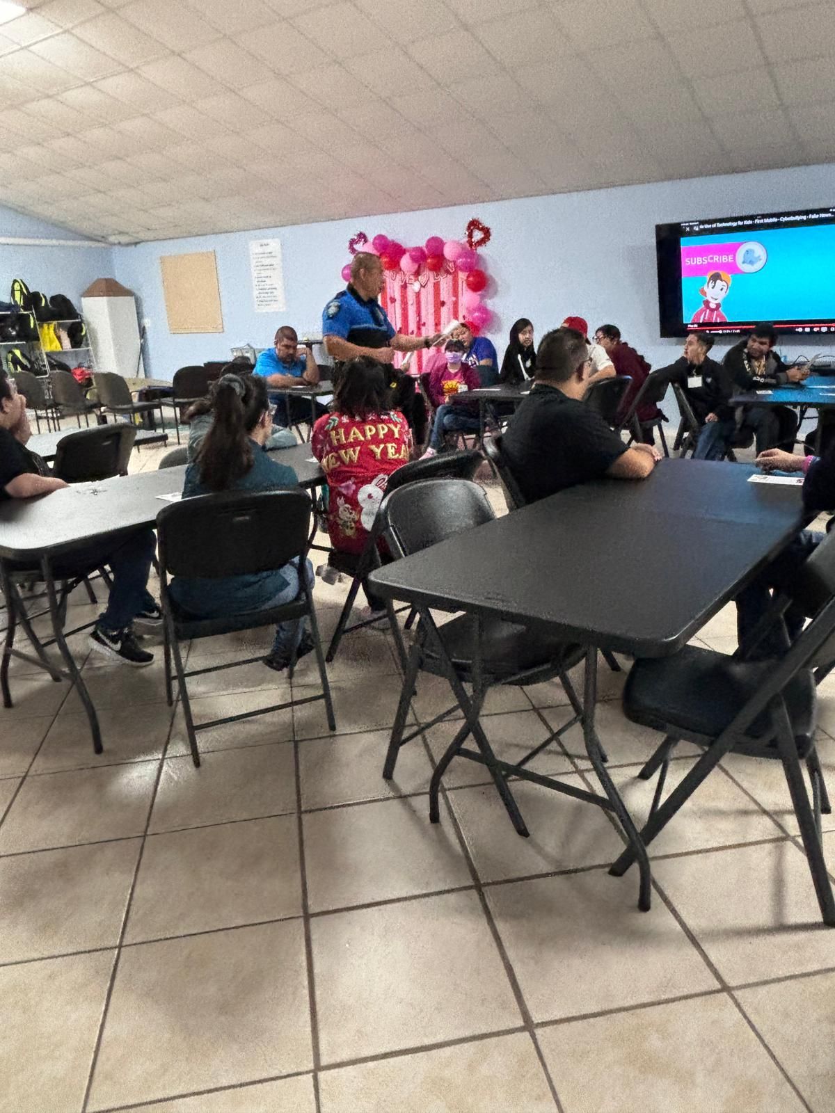 A group of people are sitting at tables in a room.