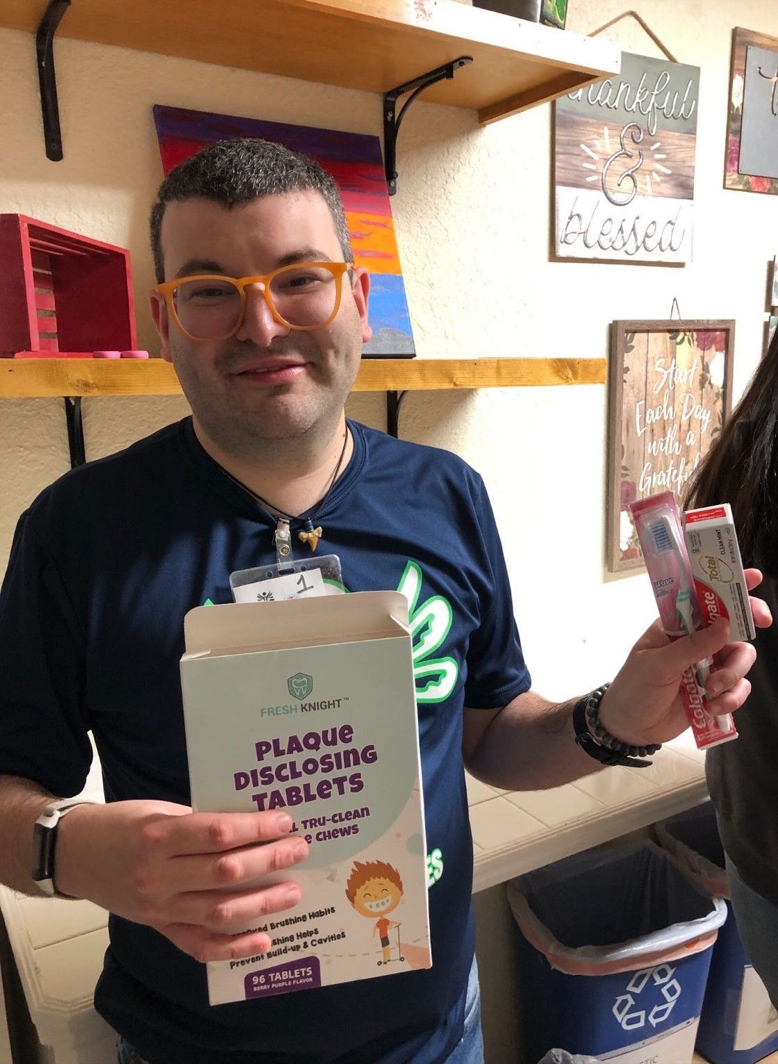 A man is holding a box of plaque dissolving tablets.
