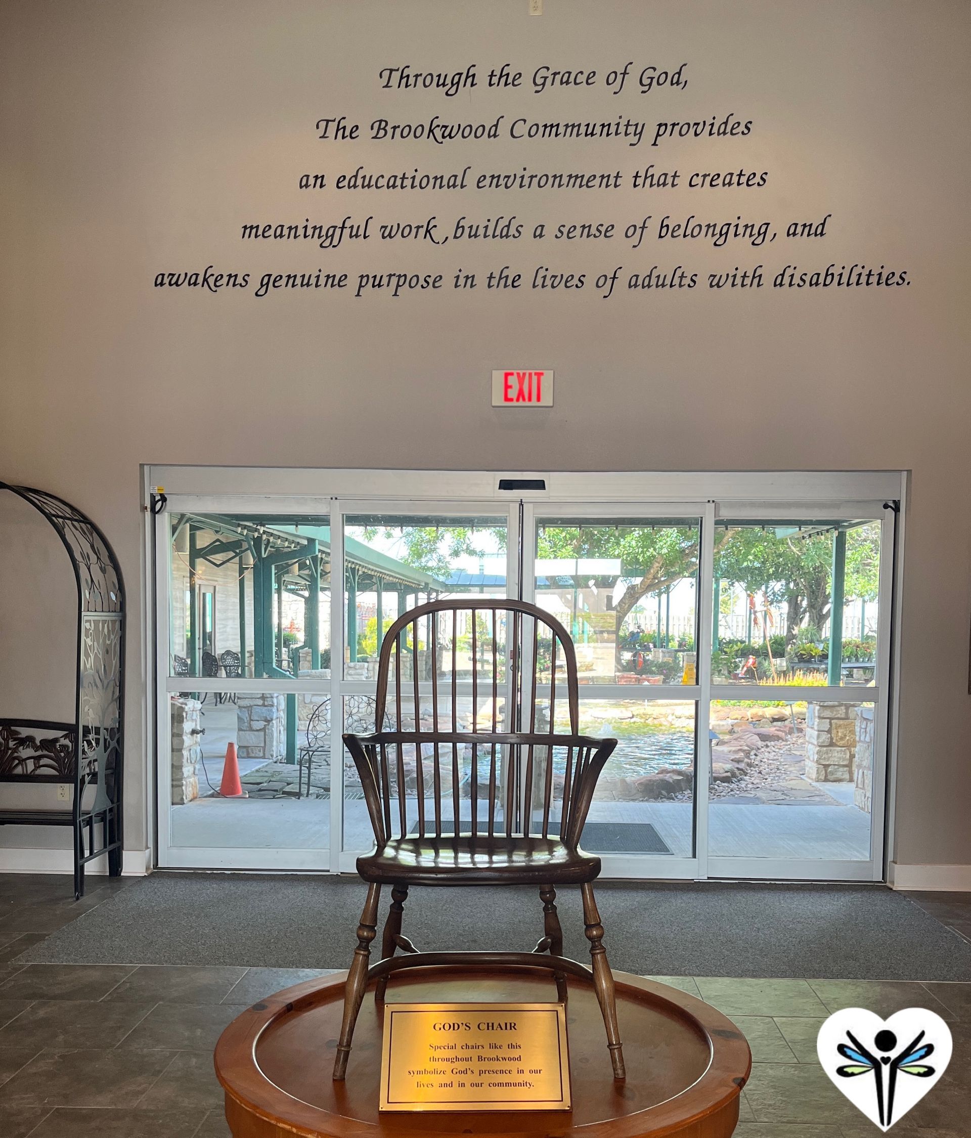 A wooden chair is sitting on a table in front of a sliding glass door.