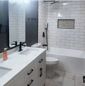 Modern bathroom with white subway tile, black fixtures, and a white vanity.