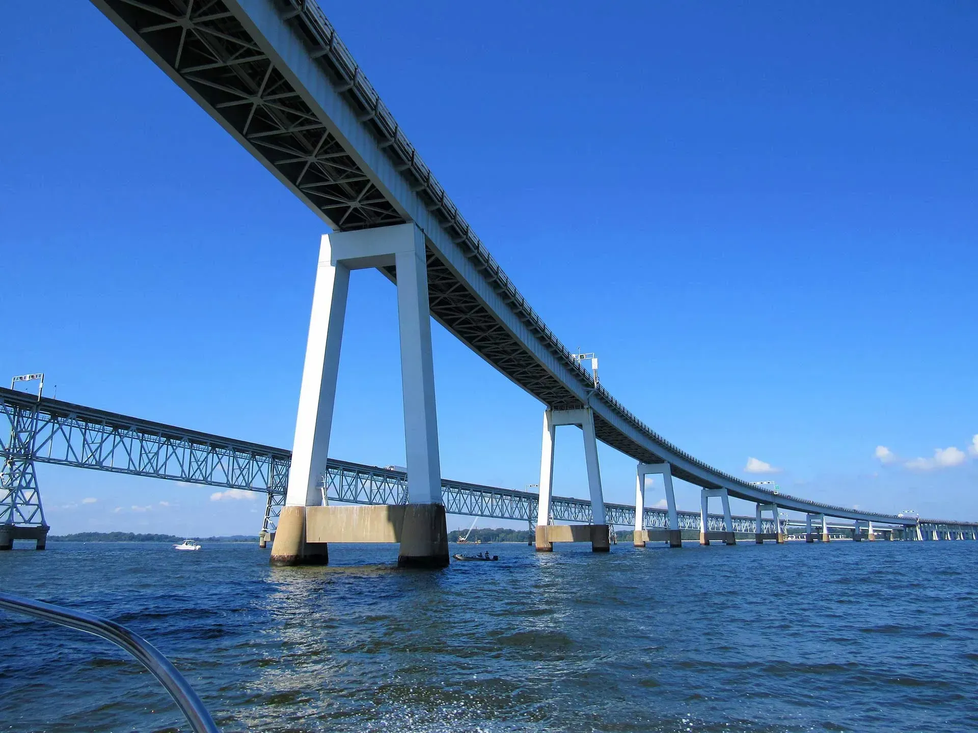 a bridge over a body of water with a blue sky in the background