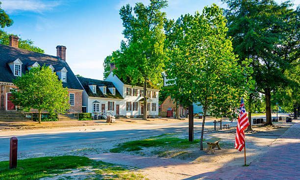 a small town with a red white and blue american flag in the middle of the street .