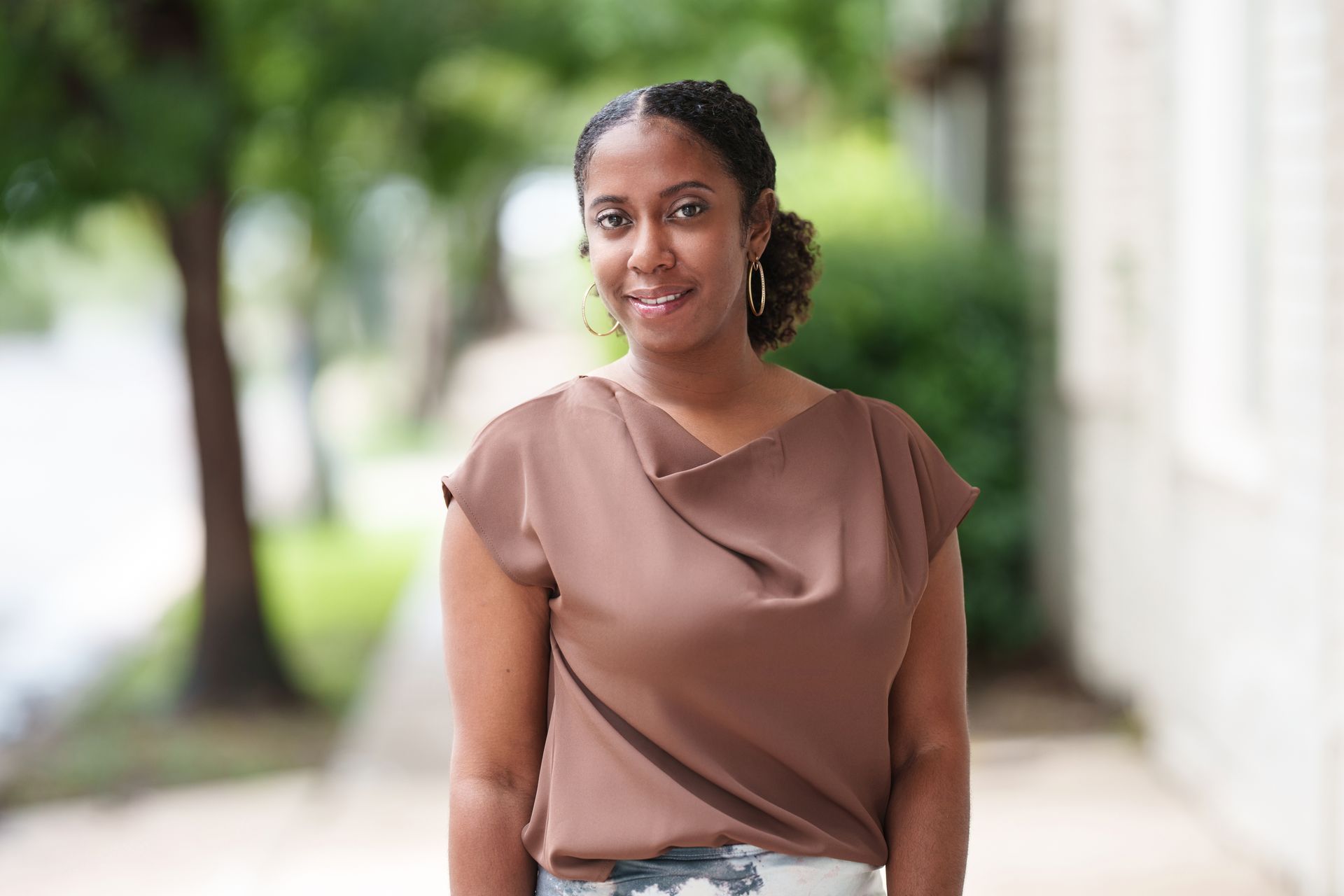 A woman is smiling with a blurred background