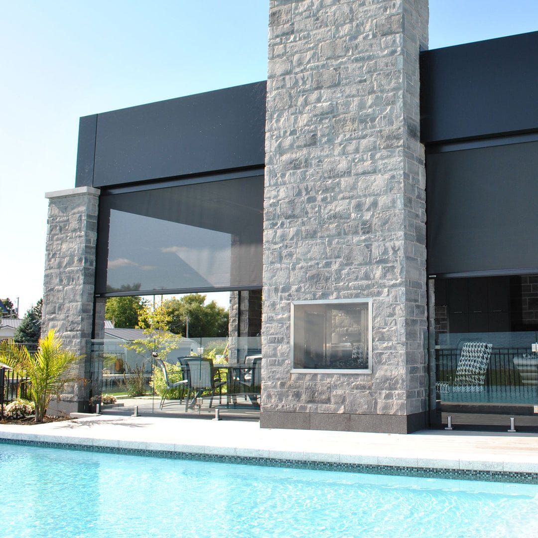 A large stone building with a swimming pool in front of it